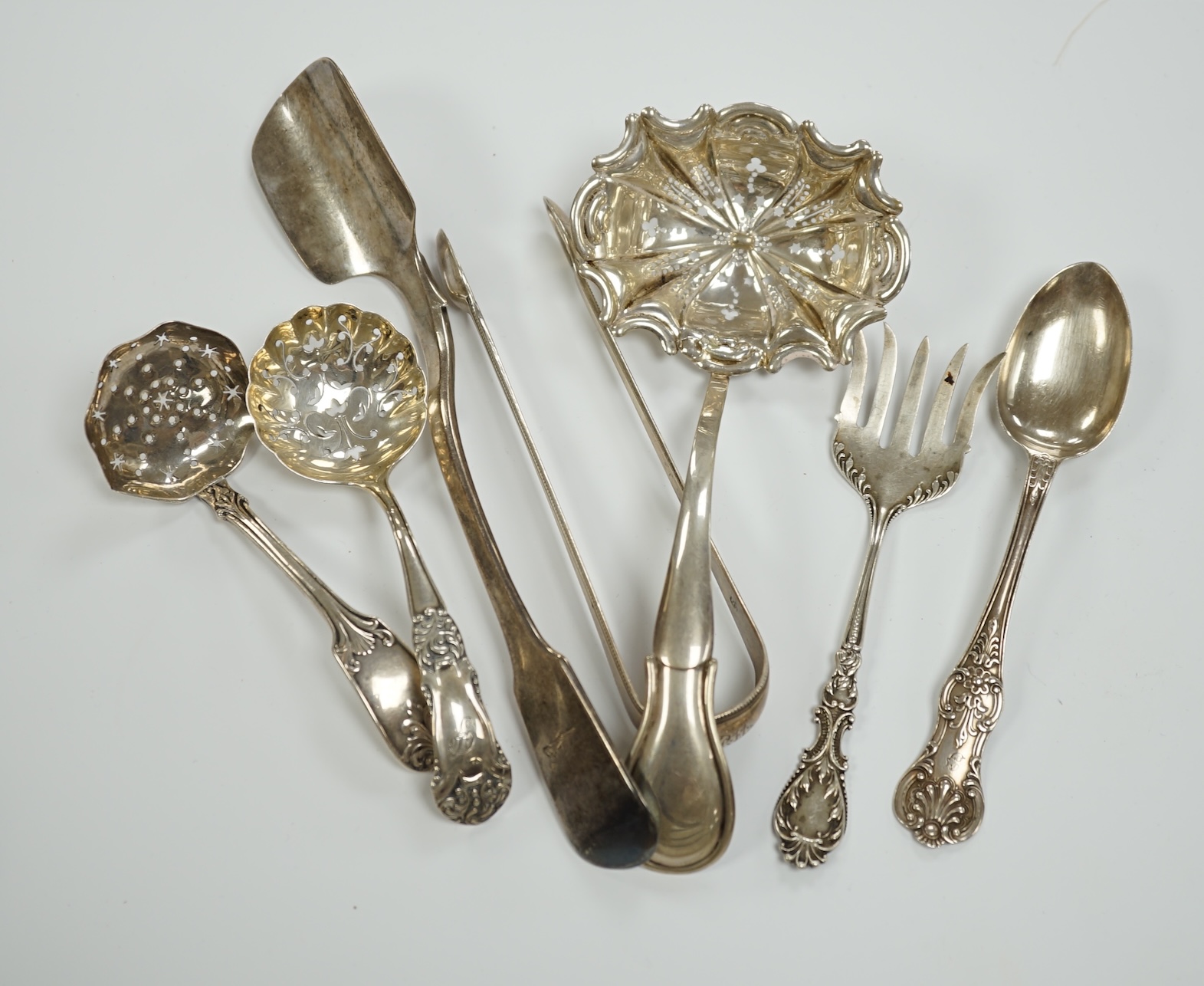 A Victorian silver fiddle pattern stilton scoop, London, 1847, 21.5cm and six other items of sundry flatware including Dutch white metal sifter spoon, smaller silver sifter spoons and a pair of Georgian silver sugar tong